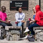 Students sat chatting outside the Doctoral College