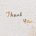 'Thank you' written in gold with gold confetti around