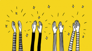 A cartoon image of black and white hands clapping on a yellow background
