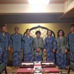 A group of people in kimonos in a restaurant