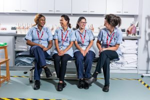 Nursing students laughing in one of the simulation wards