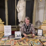 julia at a table covered in gothic comics